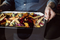 Man holding a Casserole Dish with mixed Vegetables