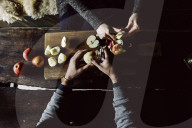 Couple peeling and cutting Apples