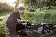 Man cooking at a Camp Fire