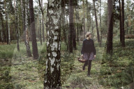 Woman collecting Mushrooms in the Forest
