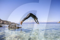 Woman in wetsuit is diving