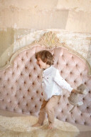 Boy with Soft Toy frolics on a Bed
