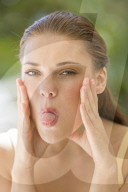 Young woman sticking out tongue