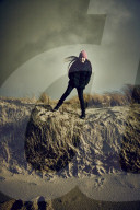 Girl jumping from a Dune in Rantum, Sylt