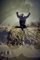 Girl jumping from a Dune in Rantum, Sylt
