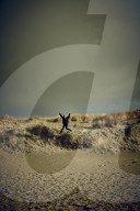 Girl jumping from a Dune in Rantum, Sylt