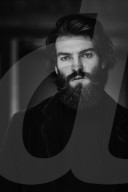 Portrait of a Manwith Full Beard wearing a blue Jacket