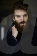 Portrait of a Man with Full Beard wearing a blue Jacket