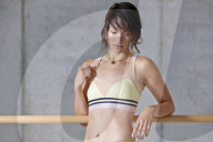 Sporty young Woman leaning on a Ballet Bar