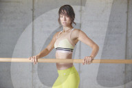 Sporty young Woman at a Ballet Bar