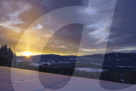 Sunrise over a snowy mountain meadow