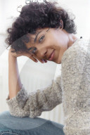 Portrait of a young Woman with ruffled and curly dark Hair
