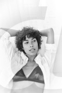 Young Woman sitting in a white Couch 