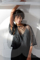 Young Woman wearing a sheer black Top  