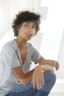 Young woman wearing a T-Shirt sitting relaxed