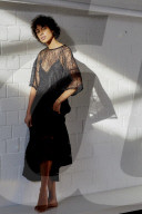 Young Woman wearing a sheer black Dress