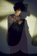 Young Woman wearing a sheer black Dress