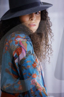Woman wearing a blue Summer Dress with Flower and Animal Prints 