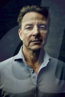 Mature Man wearing a blue Shirt  