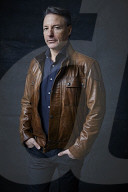 Mature Man wearing a brown Leather Jacket 