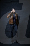 Mature Man wearing a brown Leather Jacket 