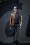 Mature Man wearing a brown Leather Jacket 