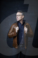 Mature Man wearing a brown Leather Jacket 