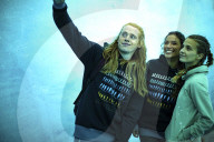 Three young friends in an ice cave