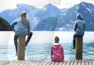 Three young guys watching lake