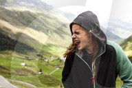 Young man eating a cherry tomato