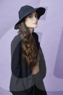  Young Woman wearing black Outfit and Hat 