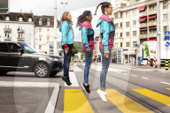 Three friends jumping on the street
