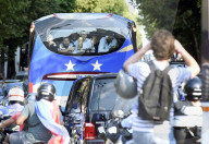Bus transporting the France's national football team arrives in Paris near the Champs Elysees