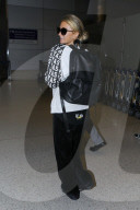 PREMIUM EXCLUSIVE Paris Hilton Returns From Cancun With A Glowing Tan