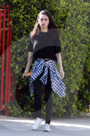 Mila Kunis flashes a hint of midriff as she runs errands on Thursday morning in LA.