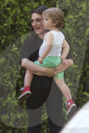 Mila Kunis flashes a big smile while carrying her son Dimitri after attending a Mommy and Me Class in Studio City!