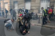 French police have fired tear gas on masked protesters who joined large May Day demonstrations in Paris.