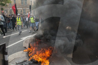 French police have fired tear gas on masked protesters who joined large May Day demonstrations in Paris.