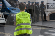 French police have fired tear gas on masked protesters who joined large May Day demonstrations in Paris.