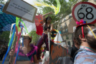 French police have fired tear gas on masked protesters who joined large May Day demonstrations in Paris.