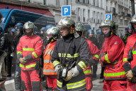 French police have fired tear gas on masked protesters who joined large May Day demonstrations in Paris.