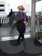 PREMIUM EXCLUSIVE Annie Lennox Arrives At LAX In Style While Rocking Vibrant Purple Scarf
