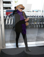 PREMIUM EXCLUSIVE Annie Lennox Arrives At LAX In Style While Rocking Vibrant Purple Scarf