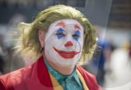 Cos Play enthusiasts arrive at Comic Con London dressed in the favourite cos play costumes.