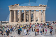 Tourist At Acropolis Hill And Parthenon In Athens 