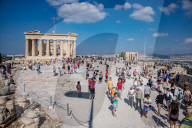 Tourist At Acropolis Hill And Parthenon In Athens 