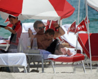 Original member of English pop band Duran Duran, Roger Taylor, was pictured enjoying a beach day in Miami Beach with his beautiful wife, Peruvian national Gisella Bernales, and their adorable 8-year-old son Julian Roger. 