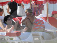 Original member of English pop band Duran Duran, Roger Taylor, was pictured enjoying a beach day in Miami Beach with his beautiful wife, Peruvian national Gisella Bernales, and their adorable 8-year-old son Julian Roger. 