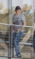 Ashton Kutcher is all smiles cruising around LA in a vintage sports car as the trial involving his ex-girlfriendÍs alleged killer reaches a climax.