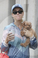 Katy Perry cuddles her adorable pet dog, Nugget, as she steps out for a meeting in Santa Monica